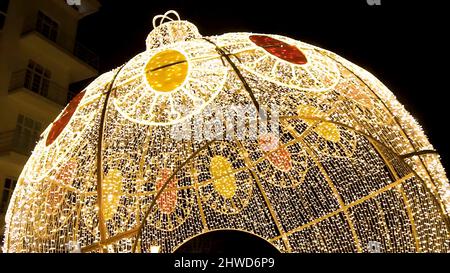 Glowing dome on the outdoor. Clip. Many lightbulbs hanging as garland decorative in festival on dark night sky background, beautiful design of light s Stock Photo