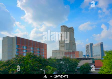 Blurred image of Kolkata, West Bengal, India. View of ITC Sonar Bangla Hotel with blue sky and white clouds in the background. A famous 5 star hotel. Stock Photo