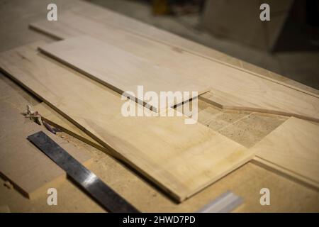 Boards on table. Joinery. Details of woodworking. Manufacture of furniture. Raw board. Stock Photo