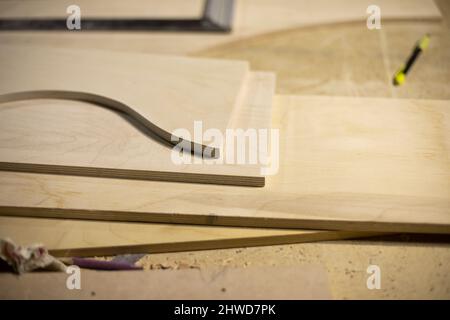 Boards on table. Joinery. Details of woodworking. Manufacture of furniture. Raw board. Stock Photo