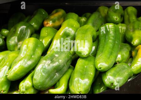 Gennevilliers, France - 01 21 2022: Primeur fruits and vegetables. Detail of green peppers at a greengrocer Stock Photo