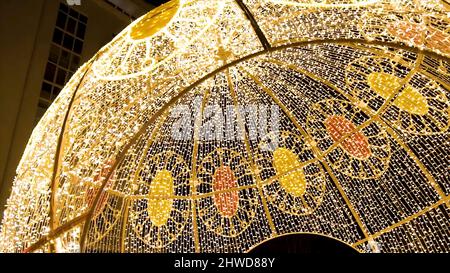 Glowing dome on the outdoor. Clip. Many lightbulbs hanging as garland decorative in festival on dark night sky background, beautiful design of light s Stock Photo