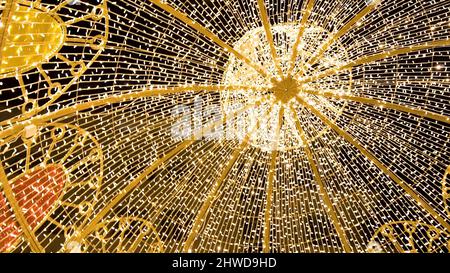Glowing dome on the outdoor. Clip. Many lightbulbs hanging as garland decorative in festival on dark night sky background, beautiful design of light s Stock Photo