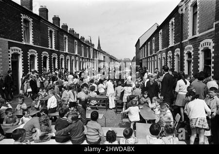 Street party in Balkan Street, Belfast. The party was organised after the street was hit by riot just a week ago after fighting broke out following the army discovering a cache of arms in the road. The party was organised for the children who had to stay in their homes because of a curfew imposed during the riots. 12th July 1970. Stock Photo