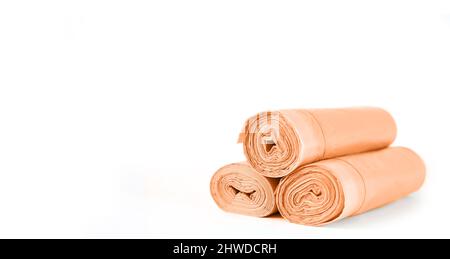 Orange rolls of garbage trash bin bags isolated on white background with copy space Stock Photo