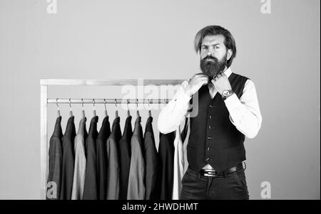 Man picking suit from personal wardrobe, male fashion concept Stock Photo