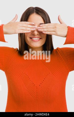 Portrait of a beautiful woman covering her own eyes Stock Photo