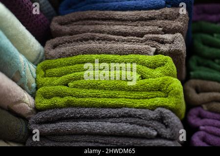Towels stacked. Towel for bathroom. Things made of fabric lie flat on the shelf. Stock Photo