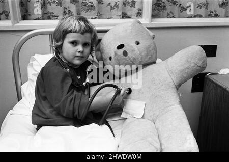 Little four year old Michelle Roberts and her big borrowed teddy bear were both progressing very nicely at Northampton General Hospital, after their 'joint' operation. When Michelle started crying as she came out of the anaesthetic after her appendix operation, there was only one thing to do - the theatre staff decided to operate on her teddy too, to show her there was really nothing to worry about. 22nd January 1969. Stock Photo
