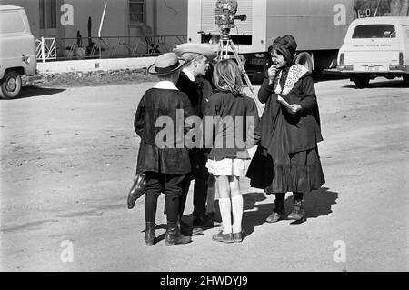 Rolling Stones: Filming Ned Kelly in Australia. Mick Jagger. Children in the street who have parts in the picture. July 1969 Stock Photo