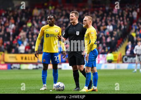 LONDON, UK. MAR 5TH Jay Matete(27) of Sunderland and Alex Pritchard(21) of Sunderland in discussion with the referee Anthony Backhouse during the Sky Bet League 1 match between Charlton Athletic and Sunderland at The Valley, London on Saturday 5th March 2022. (Credit: Ivan Yordanov | MI News) Credit: MI News & Sport /Alamy Live News Stock Photo