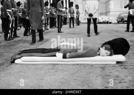 A hard days work for actor Richard Warwick who is playing Bumbo Bailey in the film 'The Breaking of Bumbo' which is being shot at Pinewood Studios. Bumbo is a young officer in the Brigade of Guards stationed at Wellington Barracks, and while on parade he faints and falls onto mattresses, but getting up and falling down can be hard work so during a break Richard has a quick lie down in his dressing room. 10th March 1970. Stock Photo