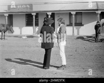 Rolling Stones: Filming Ned Kelly in Australia. Mick Jagger. Jagger outside the bank. July 1969 73-6371b-079 Stock Photo