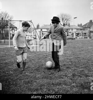 Actor Jack Wild (right) who played the role of the Artful Dodger in the 1968 Lionel Bart musical film Oliver! Pictured playing football with another boy in his local park. 28th February 1969. Stock Photo