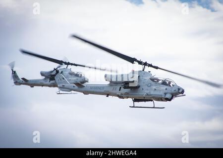 US Army Bell Cobra combat helicopter formation coming in for attack Stock Photo