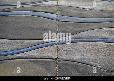 An abstract pattern of wavy lines on concrete Stock Photo