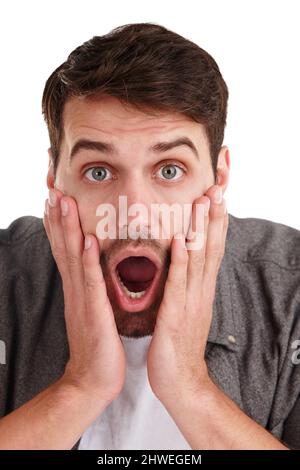 I cant believe it. Closeup studio portrait of a young man gasping with shock. Stock Photo