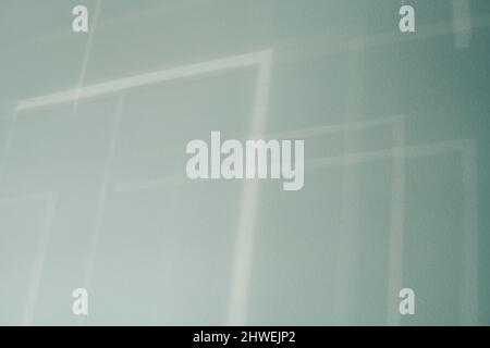 Abstract shadows from blinds on a blue wall . Stock Photo