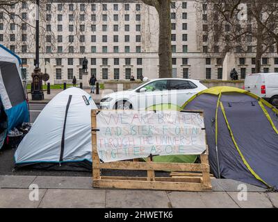 London, UK. 5th March 2022. A small group of tents on the Embankment close to Parliament is occupied by peaceful protesters from various nations who question whether we can rely on our media owned by billionaires to tell us the truth about what is happening in Ukraine and are question accounts of the war. They appear to be truthers who say our the state is failing to accord us our human rights as set out in Magna Carta and human rights treaties and are against giving children Covid vaccinations pointing out the dangerous side effects. Peter Marshall/Alamy Live News Stock Photo