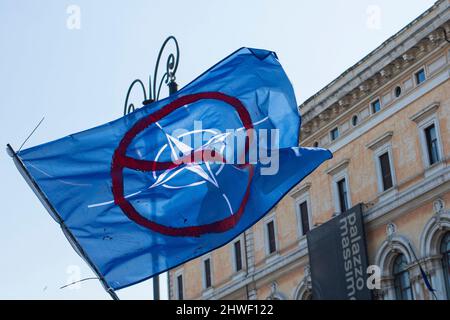Rome, Italy. 05th Mar, 2022. Protester holds a NO NATO flag during a rally against the Russian invasion of Ukraine in Rome. Credit: SOPA Images Limited/Alamy Live News Stock Photo