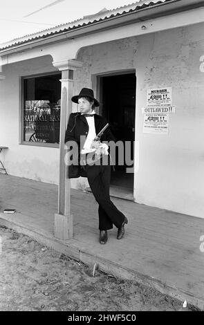 Rolling Stones: Filming Ned Kelly in Australia. Mick Jagger. Mick Jagger with gun on the verandah of the bank. July 1969 Stock Photo