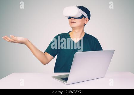 Portrait of young asian man wearing goggles virtual reality with excited isolated on white background, metaverse technology and device, innovation for Stock Photo