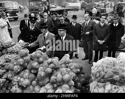 Members of Liverpool's environmental health and protection committee inspected Liverpool city market today. One of their stops was at the wholesale fruit, vegetable and flower market in Prescot Road, and the picture shows in the the foreground L-R Chief Inspector of the market J. Harrison, Mr F.W Morris, general manager of the market and committee chairman, Alderman Raymond Crane. 16th October 1970. Stock Photo