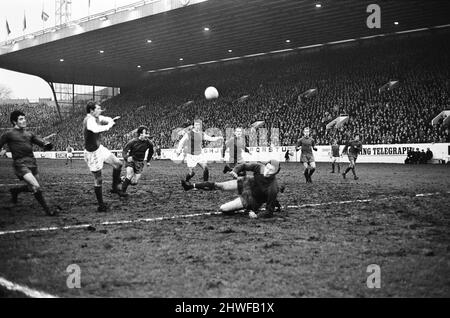 Sheffield Wednesday v Scunthorpe United FA Cup fourth round match at Hillsborough January 1970.   Wednesday's Jackie Sinclair shoots & hits Scunthorpe goalkeeper Geoff Barnard who saves.    Final score:  Sheffield Wednesday 1-2 Scunthorpe United Stock Photo