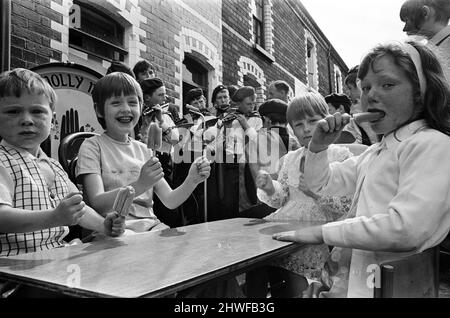 Street party in Balkan Street, Belfast. The party was organised after the street was hit by riot just a week ago after fighting broke out following the army discovering a cache of arms in the road. The party was organised for the children who had to stay in their homes because of a curfew imposed during the riots. 12th July 1970. Stock Photo