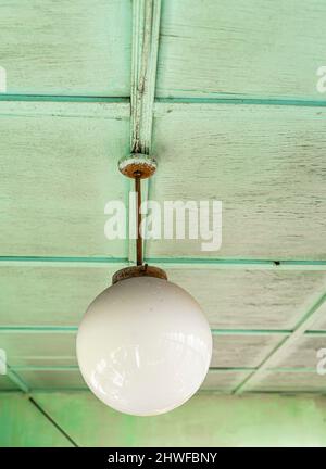 Old dusty celing light fixture in glass abat-jour, common Soviet decor Stock Photo