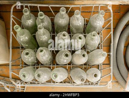 20 dusty 0.7-litre liter bottles in a metal box. Stock Photo