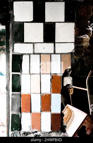 Old cracked assymetrical tiles tile on the wall Stock Photo