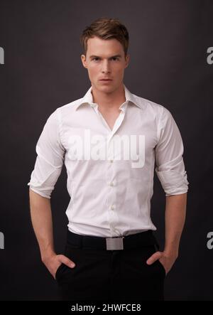 Confidence is key in winning a ladys heart. A confident young man in formal wear looking at the camera. Stock Photo