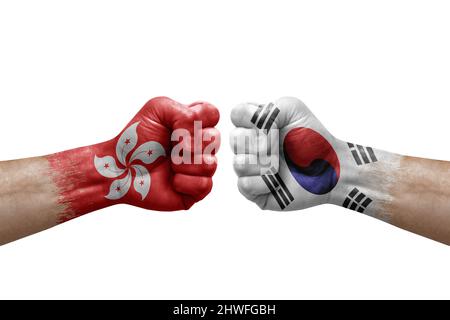 Two hands punch to each others on white background. Country flags painted fists, conflict crisis concept between hong kong and south korea Stock Photo