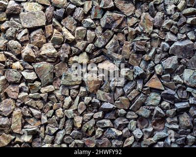Strong wall decoration with many pieces of crack stones. Rock wall texture background. Stock Photo