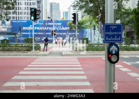 Bangkok THAILAND - February 15, 2022: Perspective view of Push button for pedestrian crossing on Phya Thai Road, in front of Ratchathewi District Offi Stock Photo