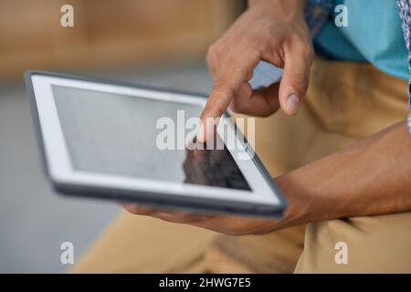 Unlock the world with a touch of your hand. Cropped image of someone working on a digital tablet - closeup. Stock Photo