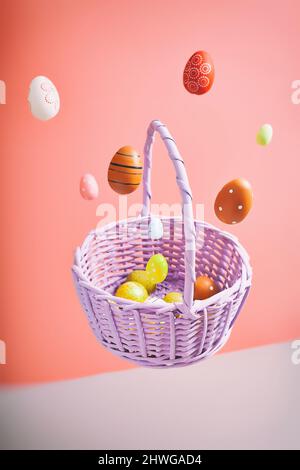 Easter eggs falling into a flying basket, Easter holiday concert Stock Photo