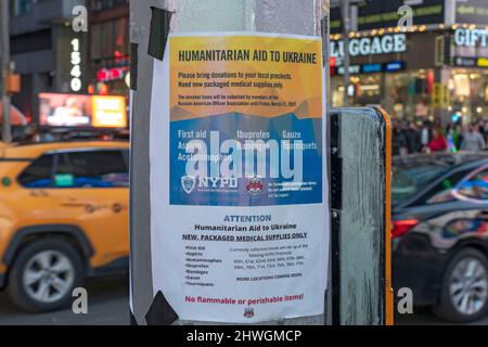 NEW YORK, NEW YORK - MARCH 05: NYPD poster asking for donations to Ukraine seen at the 'Stand With Ukraine' rally in Times Square on March 5, 2022, in New York City. Ukrainians, Ukrainian-Americans and allies gathered to show support for Ukraine and protest against the Russian invasion. Credit: Ron Adar/Alamy Live News Stock Photo