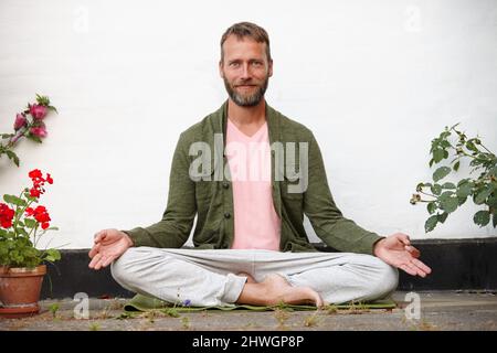 Mind over matter. Portrait of a handsome mature man doing yoga in an outside courtyard. Stock Photo