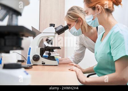 Two lab technicians or scientists working in laboratory Stock Photo