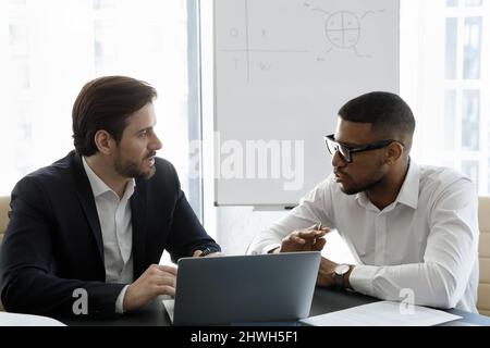 Happy focused young multiracial employees working on computer. Stock Photo