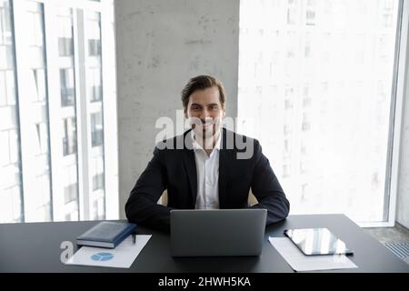 Smiling 30s young businessman looking at camera. Stock Photo