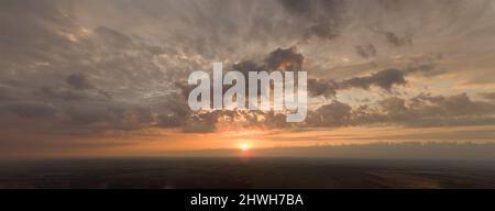 Panorama sunrise gray clouds orange sun. Stock Photo