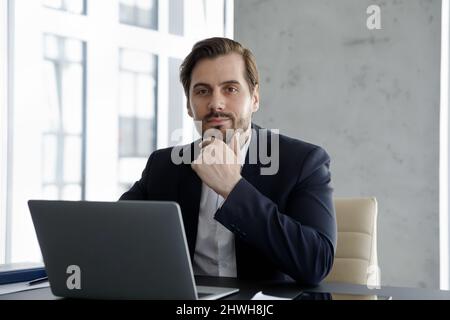 Portrait of happy young confident handsome businessman. Stock Photo