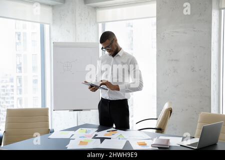 Happy successful young African American businessman using digital tablet. Stock Photo