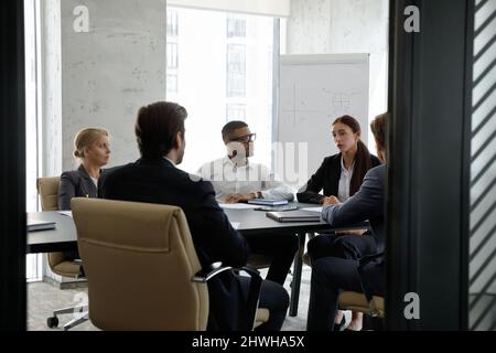 Concentrated diverse business people discussing working issues in office. Stock Photo