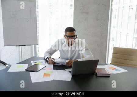 Concentrated young African American businessman holding video call. Stock Photo