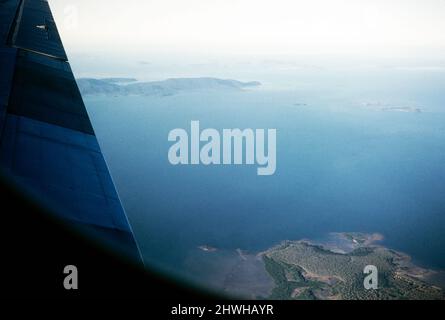 Oblique angle view of coast and islands, foreground is Midge Point, towards the Repulse Islands and Whitsunday Islands, Queensland, Australia 1956 Stock Photo