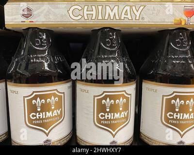 Liege, Belgium - March 3. 2022: Closeup of beer crates with bottles with logo lettering of belgian chimay brewery in supermarket Stock Photo